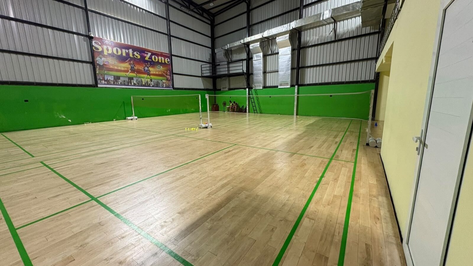 Badminton court with proper court markings and sports lighting at Sports Zone LLP, Patna