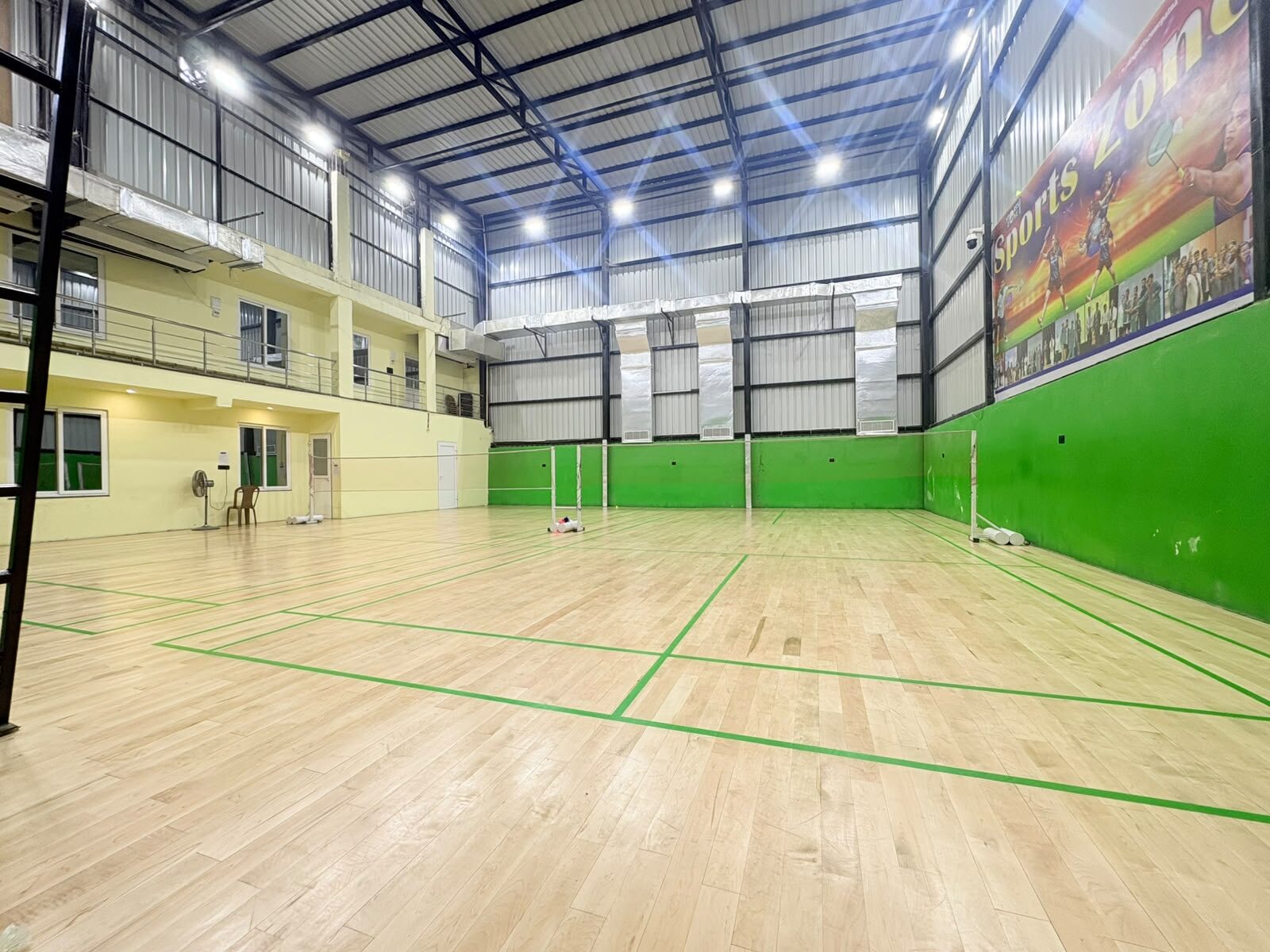 Full view of the air-conditioned wooden Badminton courts at Sports Zone LLP