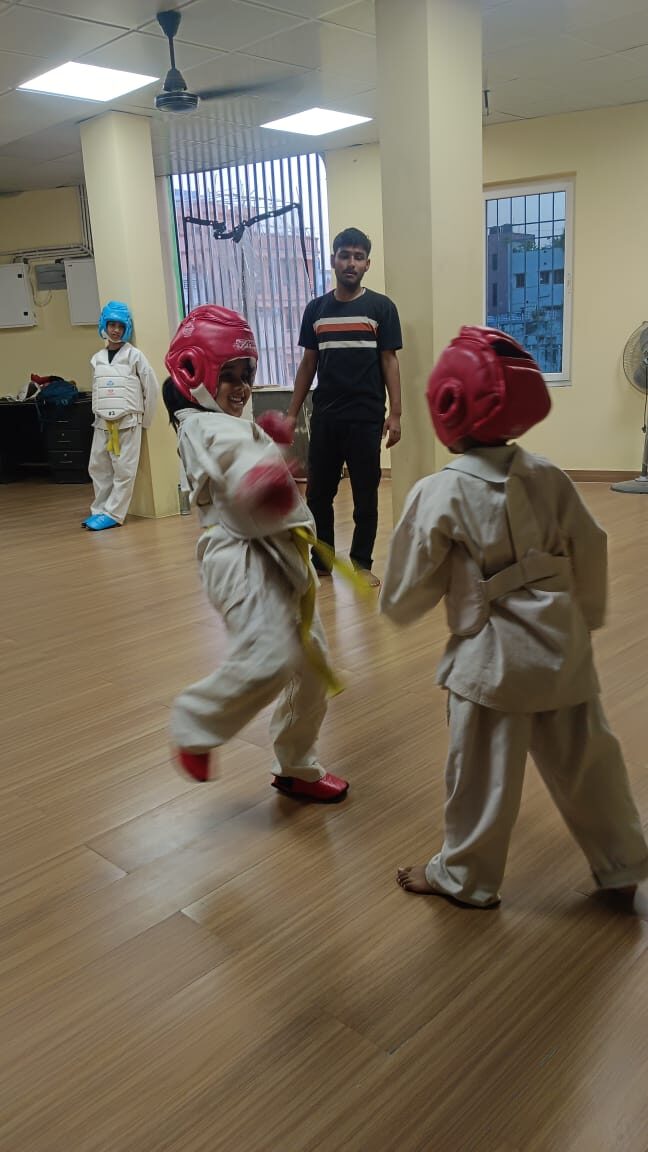 Young Karate students in padded gear practicing sparring technique at Sports Zone LLP, Patna