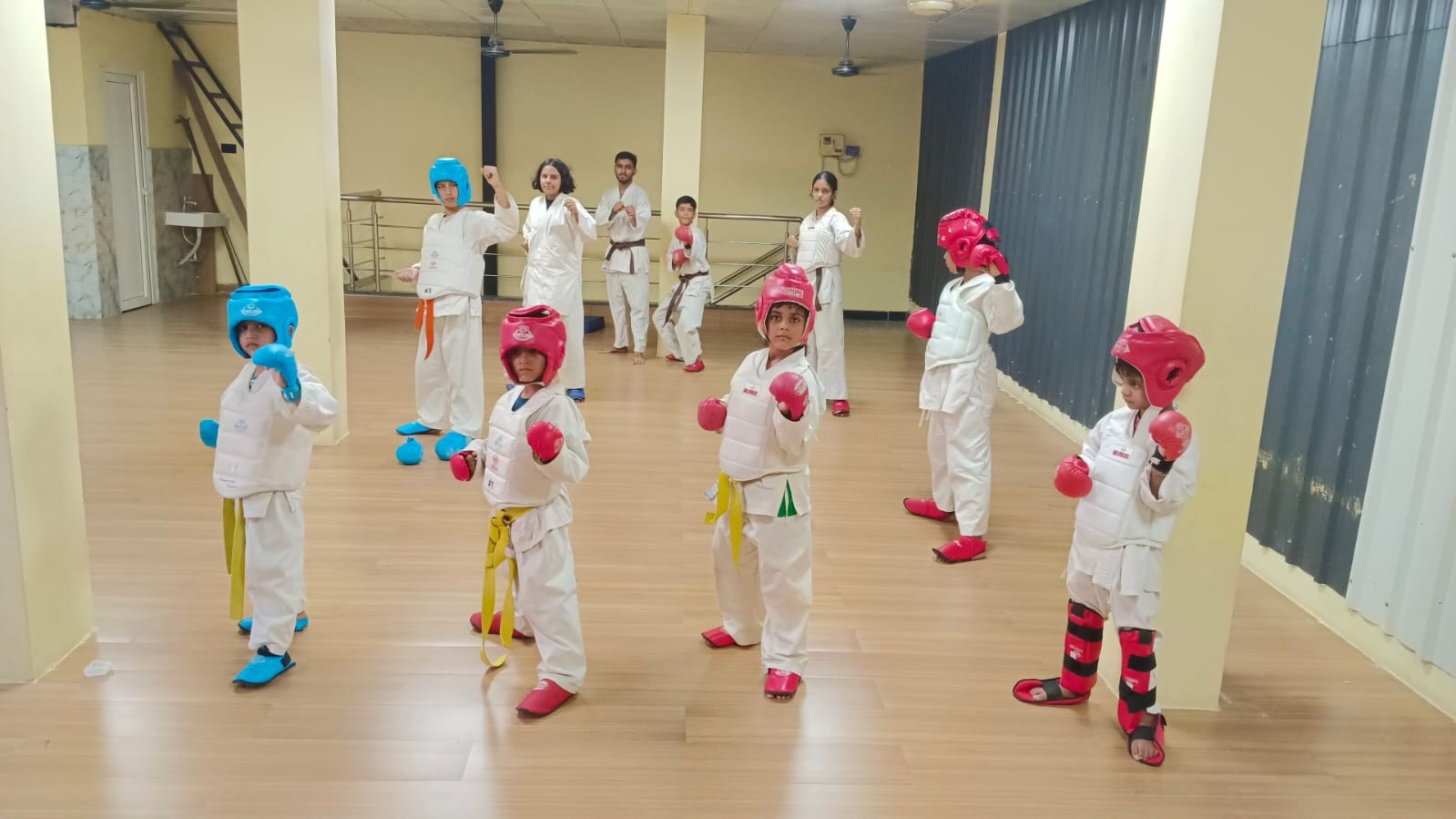 Young Judo and Karate students in sparring gear with their coaches at Sports Zone LLP, Patna