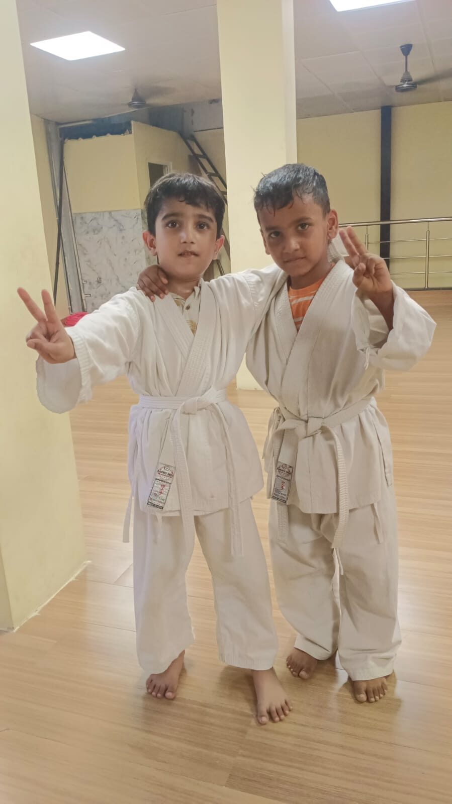 Two young Karate students in uniform posing after class at Sports Zone LLP, Patna