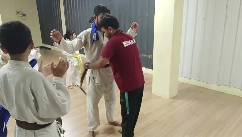Video of a coach tying a new belt on a student during a Karate grading moment at Sports Zone LLP, Patna